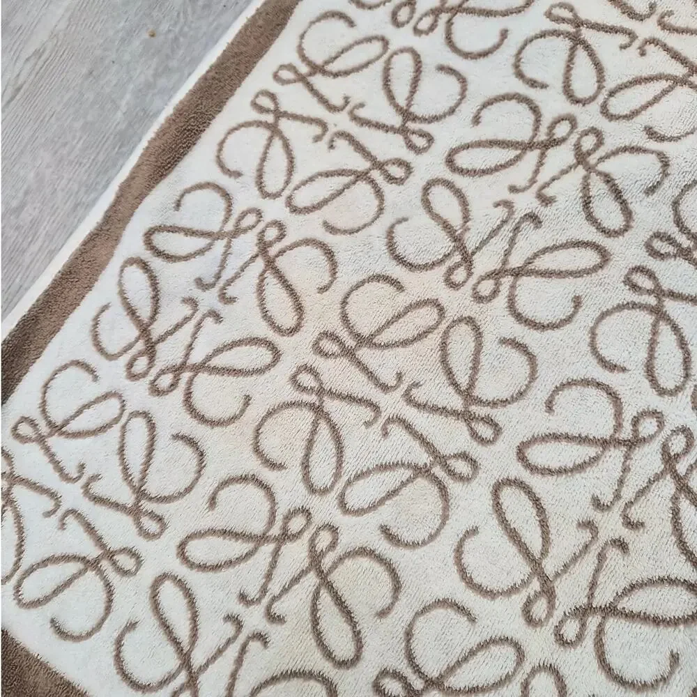 $750 Loewe Anagram towel in cotton